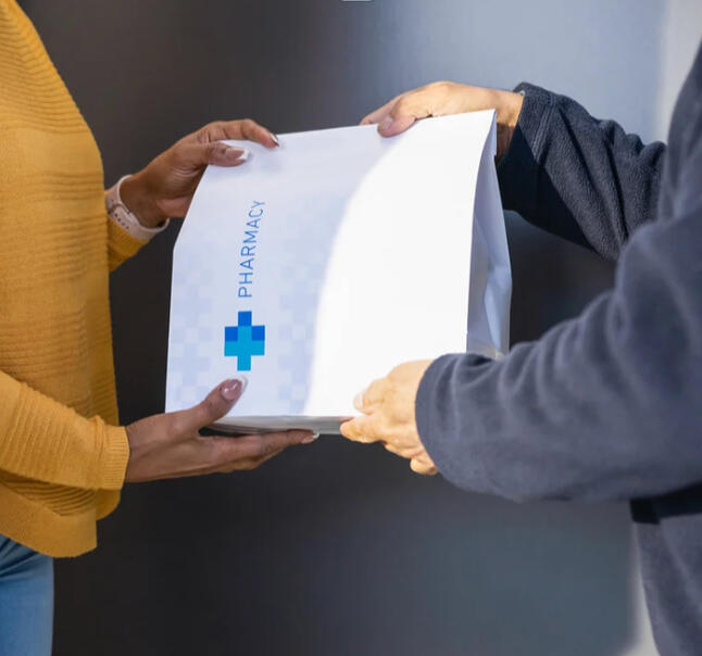 A woman taking prescription delivery from her door