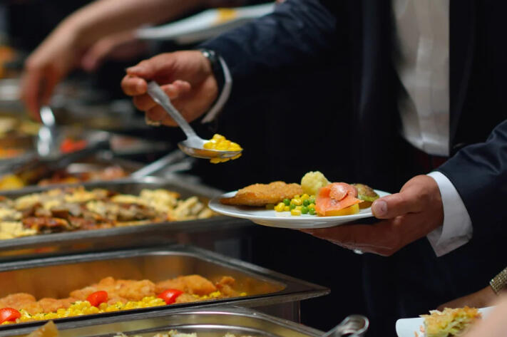 Hot steaming street food being put into a small container